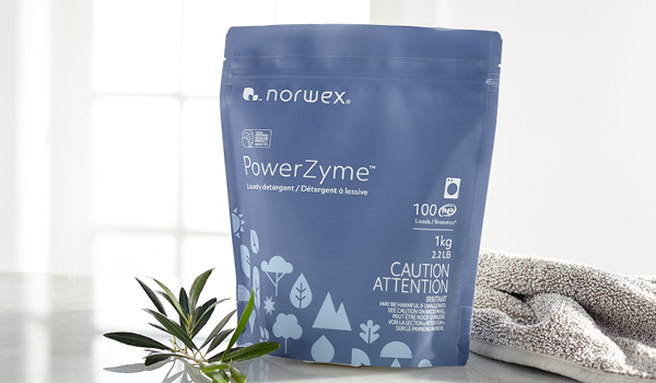 French Bulldog on a couch with dirty paws and Norwex microfiber cloth and Pet stain and odor remover.